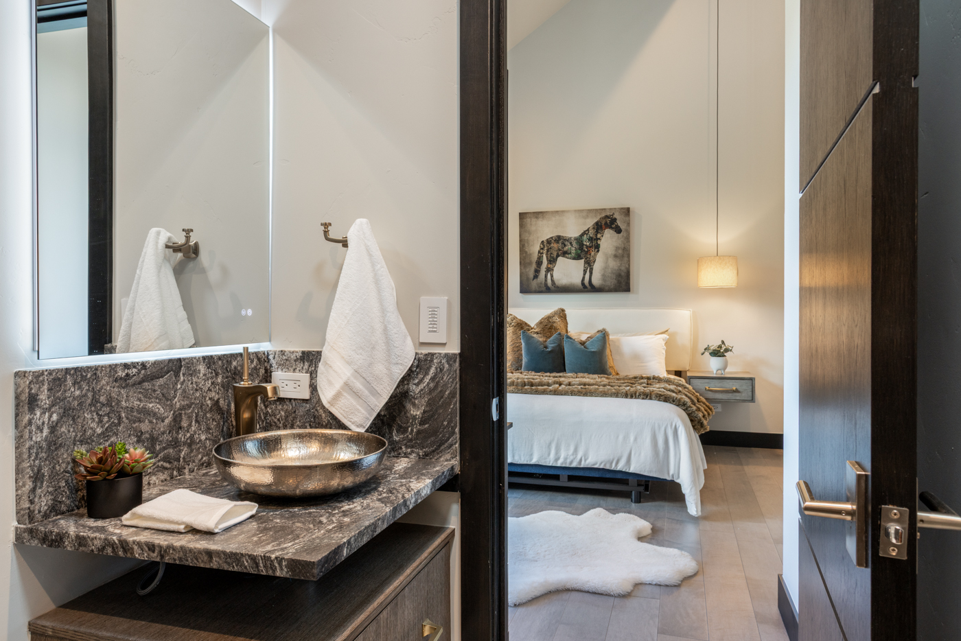 Guest ensuite vanity with hammered basin and stone counter
