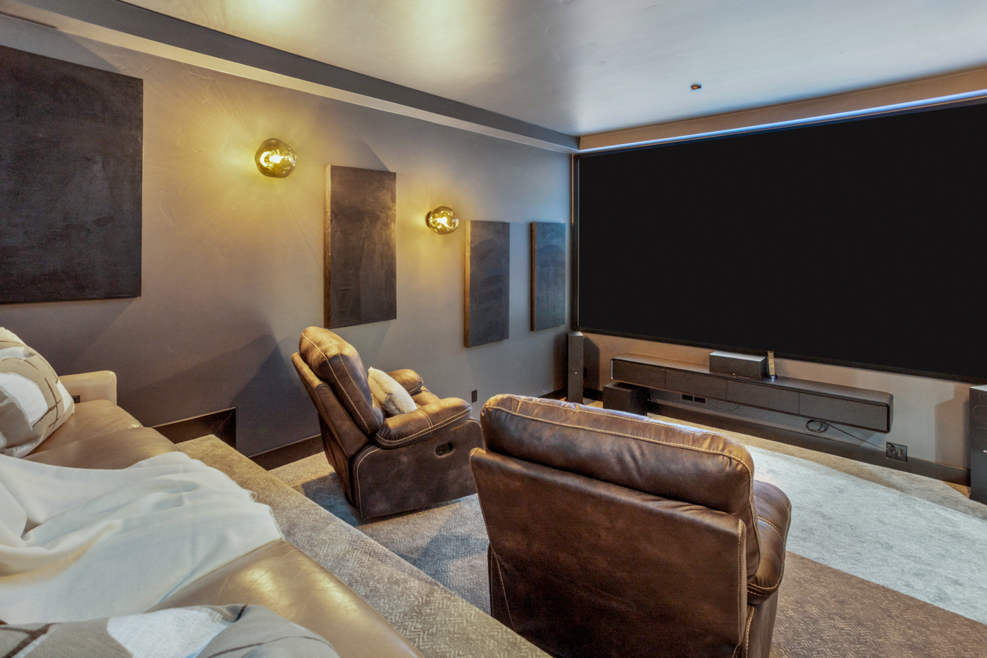 Theater screen with recliners and integrated sound system