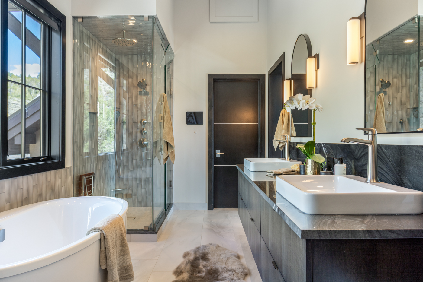 Primary bath with dual vessel sinks and oversized glass shower