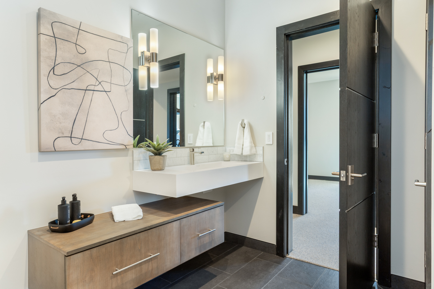 Guest bath vanity opening to the adjacent bedroom
