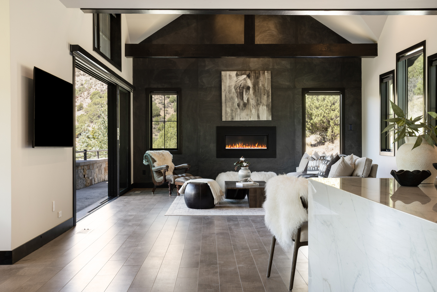 Great room with linear fireplace opening to the terrace