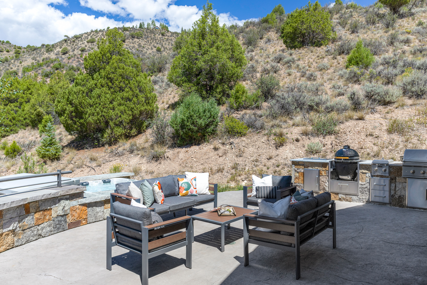 Hot tub, lounge seating, and outdoor kitchen