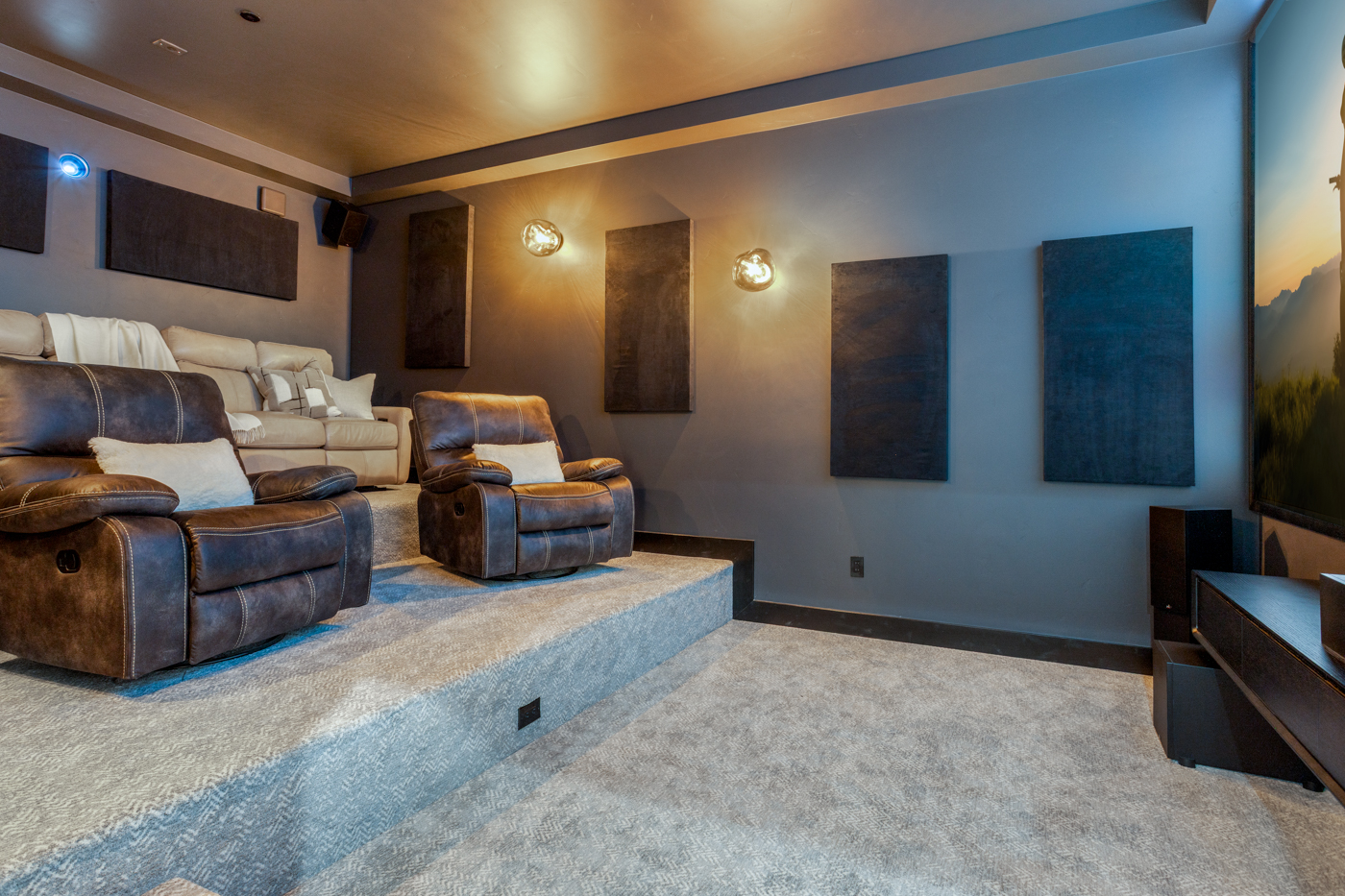 Home theater with tiered recliners and acoustic panel walls
