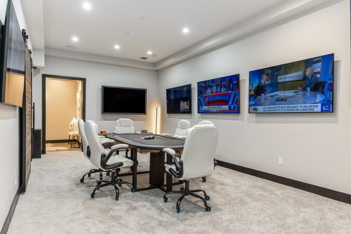 Poker room with four-screen viewing wall and executive seating