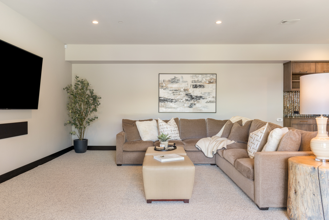 Family room with sectional seating and wall-mounted television