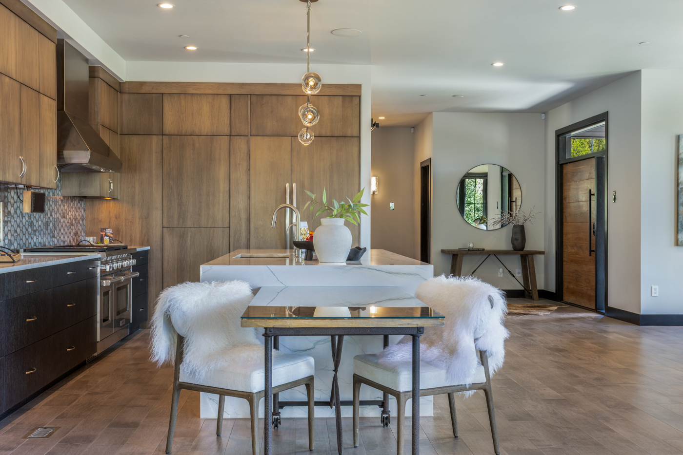 Kitchen island with attached glass-top breakfast table
