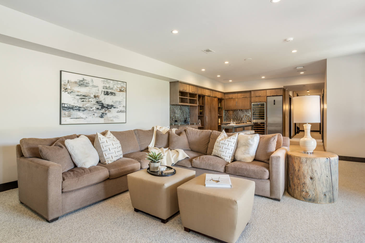 Lower-level lounge with sectional and dual ottomans